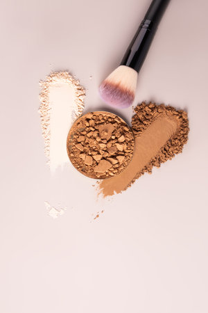 Two beautiful samples of compact powder in different tones, a block of powder broken into pieces and...