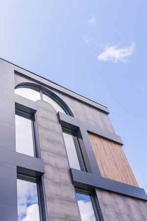 The front of the administrative or business building is brown with large frame windows. Urban...