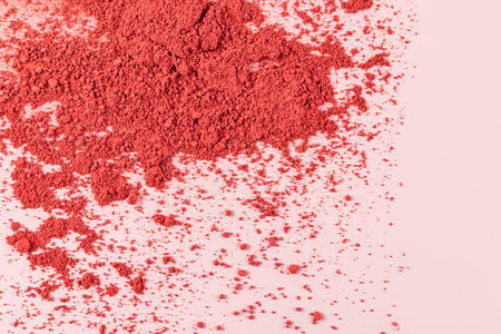 A dry pink blush is scattered on a pink background. A sample texture of decorative cosmetics. top view. A copy of the space. layoutの写真素材