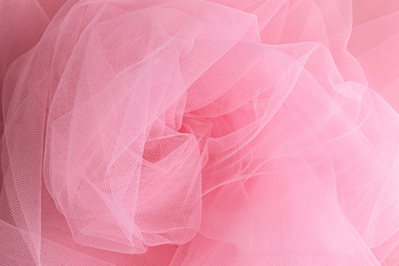 light air swirls of a delicate pink veil. Beautiful wedding or holiday mockup for design. A copy of the space. Pink fabric textureの写真素材