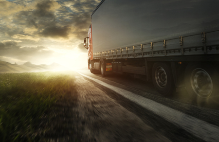 Truck at sunset on the roadの写真素材