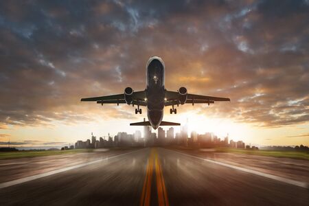 Airplane landing at sunsetの写真素材