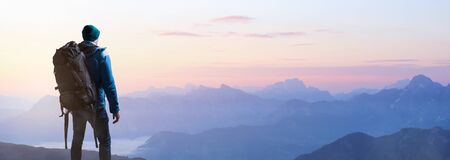 Hikers at sunrise on a mountain topの写真素材