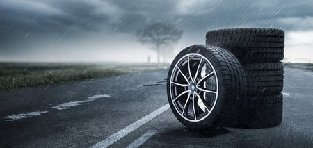 Conceptual image of a car tire on an asphalt road.の写真素材