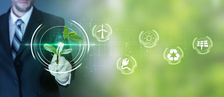 <p>Ecology concept. Businessman hand holding green sprout with environmental icons</p>の写真素材