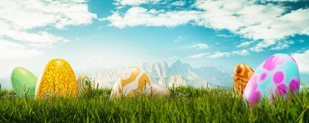 Easter eggs on green grass against high angle view of dolomitesの写真素材
