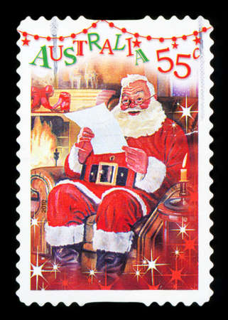 AUSTRALIA - CIRCA 2010: A used postage stamp from Australia, depicting a festive scene of Santa Claus reading a letter by the fireplace, circa 2010.のeditorial素材