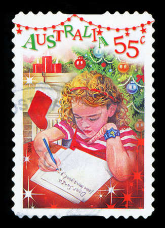 AUSTRALIA - CIRCA 2010: A stamp printed in Australia shows Girl writing letter to Santa Claus, circa 2010のeditorial素材