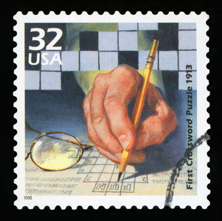 UNITED STATES OF AMERICA - CIRCA 1998: A stamp printed in USA shows First crossword puzzle published, 1913, series Celebrate the Century, 1910s, circa 1998のeditorial素材