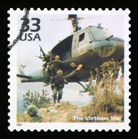UNITED STATES OF AMERICA - CIRCA 1999: A postage stamp printed in USA showing an image soldiers jumping from a military helicopter during the Vietnam war, circa 1999.のeditorial素材