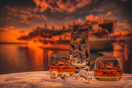 Whiskey with ice in a glass, boat, sea, 3d render.の写真素材
