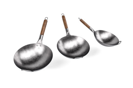 Chinese food frying pan - set of three wok pans with wooden handle isolated on white background - 3d renderの写真素材