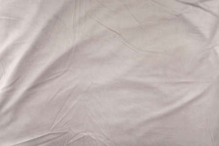 The texture of the crumpled fabric - top view and a close-up of a piece of beige, heavily crumpled velvetの写真素材