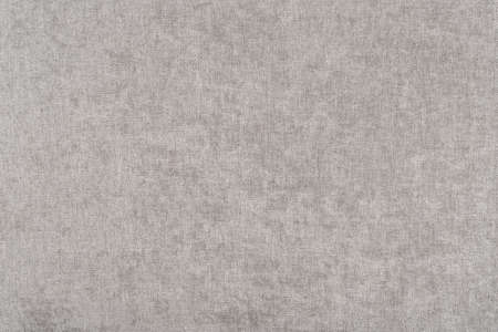 The texture of a light beige canvas - top view and a close-up of a fragment of a sofa upholsteryの写真素材