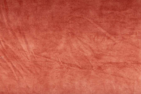 Red velvet texture - top view and close-up of a fragment of crumpled red velvetの写真素材