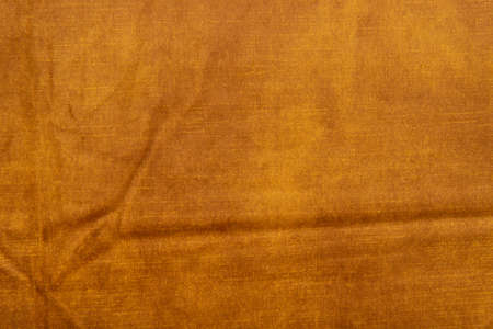Velvet fabric texture - top view and close-up of a fragment of crumpled orange velvetの写真素材