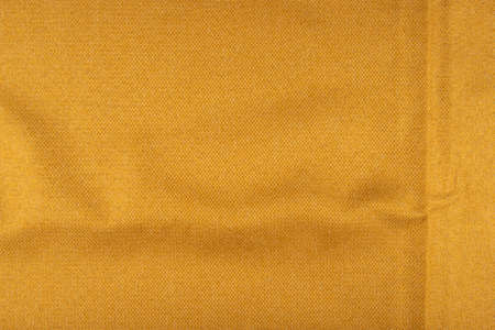 Yellow fabric texture - top view and close-up on a piece of crumpled linen fabricの写真素材