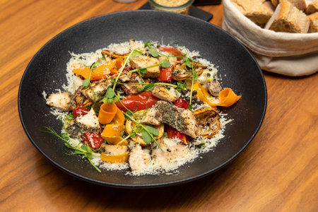 Food photography - Grilled chicken breast with Parmesan cheese and vegetables.の写真素材