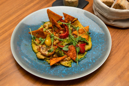 Food photography - Zucchini puree with nachos, peppers, grilled zucchini, and chickpeas.の写真素材