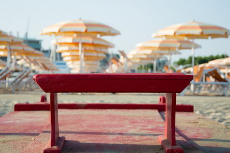 Travel beach Romagna - beach and sea in Rimini with red rescue boat closeupの写真素材