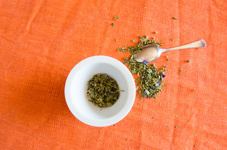 Mallow herbal tea cup on orange backgroundの写真素材
