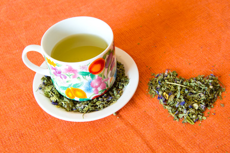 Mallow herbal tea cup on orange backgroundの写真素材