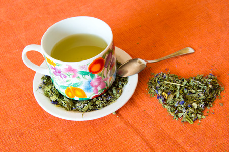 Mallow herbal tea cup on orange backgroundの写真素材