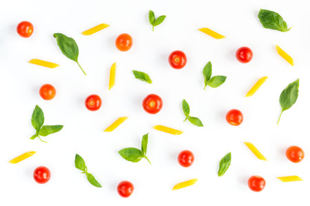 Italian food pattern with red tomatoes, pasta, basil leafs isolated on white backgroundの写真素材
