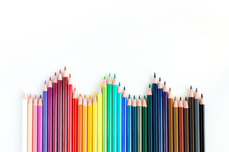 Crayons and watercolor pastels lined up isolated on white backgroundの写真素材