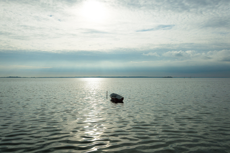 Alone boat on Denmark. Fjord on sea with cloudy skyの写真素材