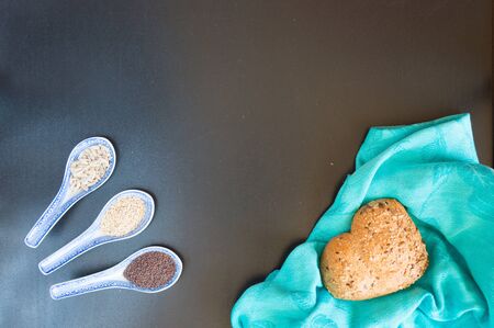 Heart shape of wholemeal bread on blackboard backroundの写真素材