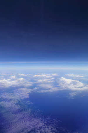 beautiful white clouds in blue sky, view from an air plane window.の写真素材