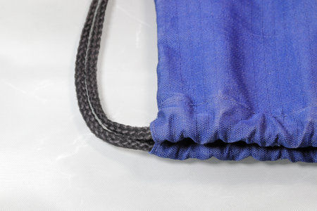 Close up gray drawstring bag or backpack with laces,  Sport bag isolated on white background.