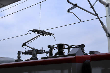 Pantograph of an electric train connecting the train to the overhead catenary wireの写真素材