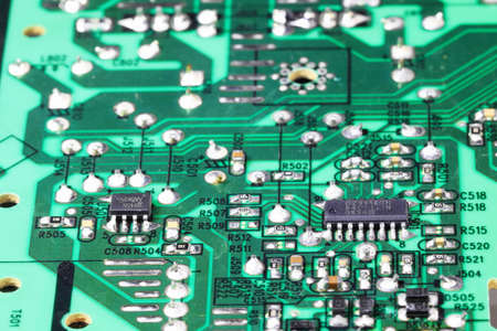 Old Printed Circuit Board with many electrical components.の写真素材