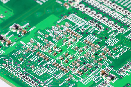 Old Printed Circuit Board with many electrical components.