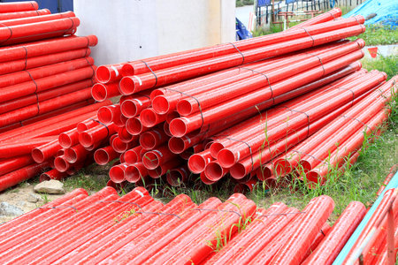 Red Fiberglass pipes at construction site, Corrosion resistant fiberglass composite pipe used in...