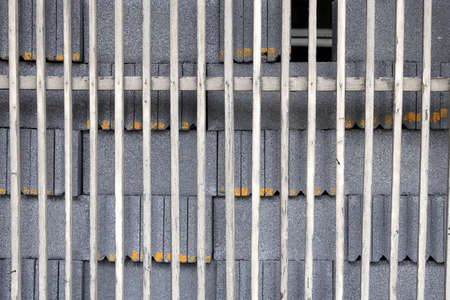 Pile of Concrete Block behind old scantling wood fence, Texture background.の写真素材