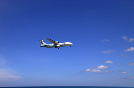 Airliner or Passenger plane Bangkok Airways ATR 72-600 landing to airport next to the beach....