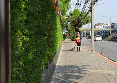 Street cleaners, Road sweeper worker cleaning street with broom tool.の写真素材