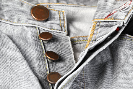 Close up Fashion Buttons on jeans, denim with seam of fashion design.