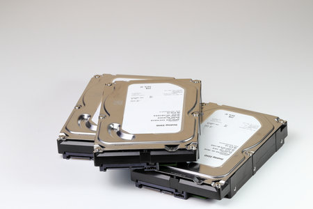 pile or stack of HDD, SSHD Hybrid hard disk drives 3.5" standard profile show on SATA interface, isolated on white backgroundの写真素材