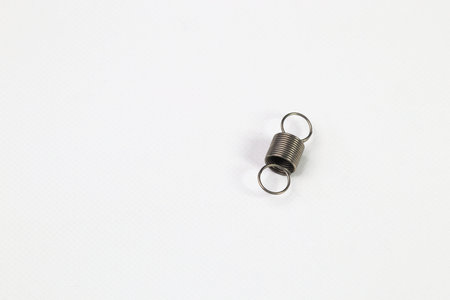 metal tension spring for different purposes, many small chrome springs, Metal spring isolated on...