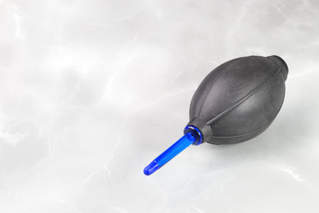 rubber blower for camera lens cleaning, Black and blue Rubber Blower isolated on White Background.の写真素材