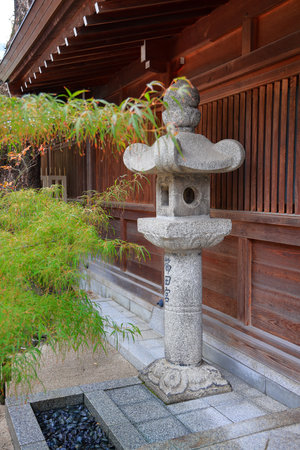 Japanese stone lantern in the garden, beautiful Autumn scenery in Japan.の写真素材