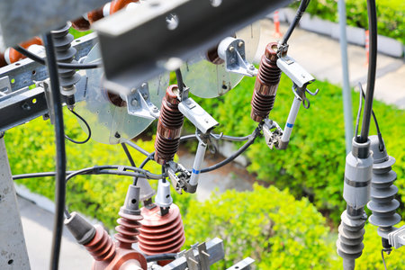 High Voltage Fuses on High voltage pole, off load switch Three-phase high-voltage fuses mounted on steel beams Wire connection on concrete electric pole.の写真素材