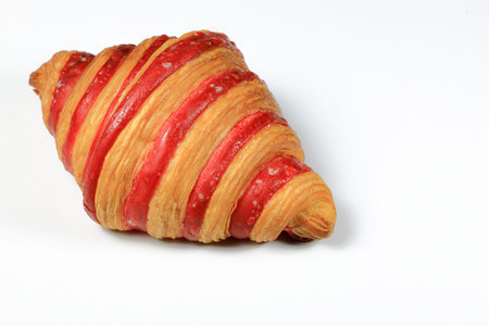 Freshly baked croissant, Double Rasberry croissant isolated on white background. French pastry closeup photo. Buttered bread croissant.の写真素材