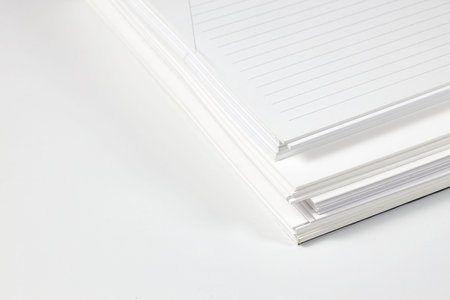 Close up stack of note papers isolated on white background.  Stationery item.