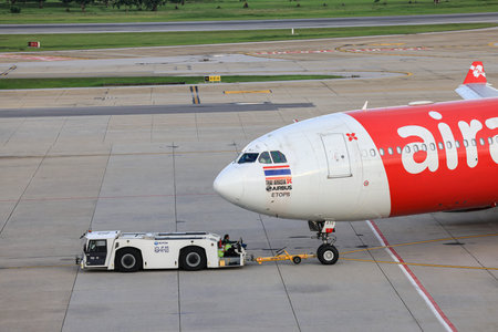 Aircraft are pushed back to the taxiway by airplane tugs, with one in ground handling services at Don-Mueang International Airport.のeditorial素材