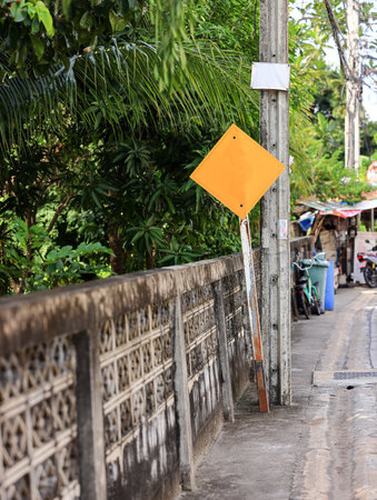 Curved road traffic yellow sign, yellow road sign, direction sign on road.の写真素材